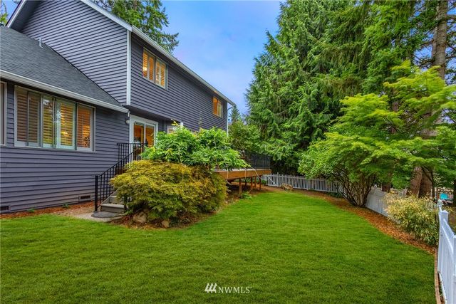 a view of a backyard with plants and a patio