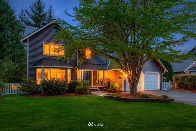 a front view of house with yard and outdoor seating