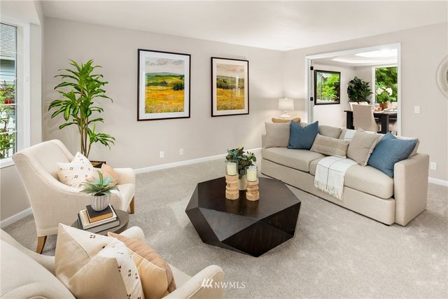 a living room with furniture and painting on the wall