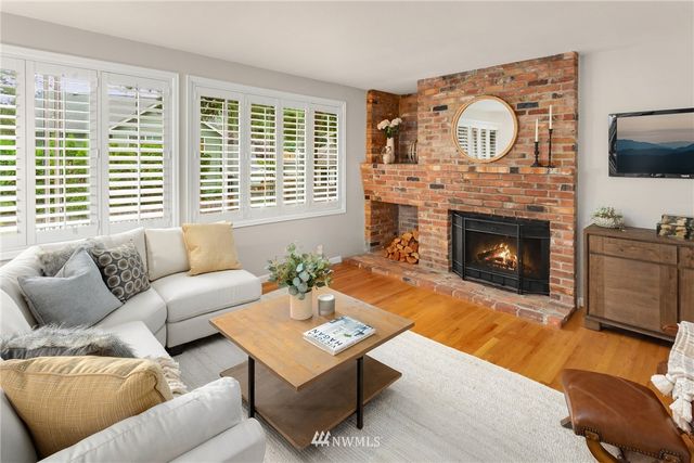 a living room with furniture fireplace and flat screen tv