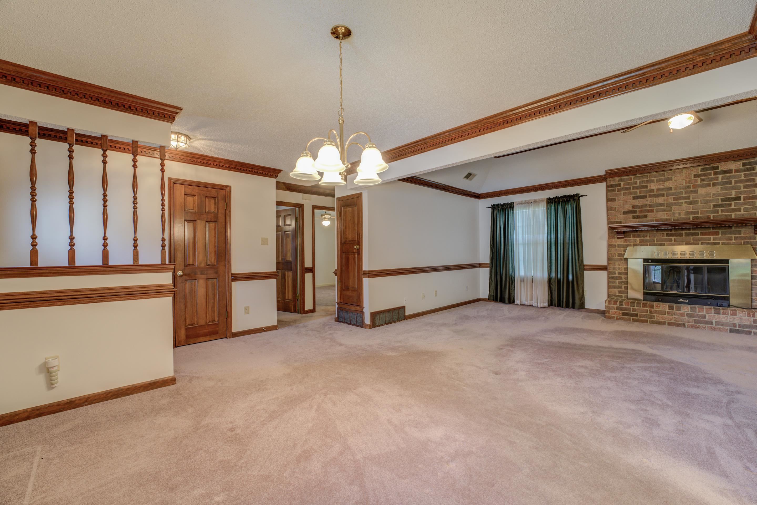 6433 Yale Road Bartlett, TN 38134 - Photo 15 of 24 a view of an empty room with chandelier and a fireplace