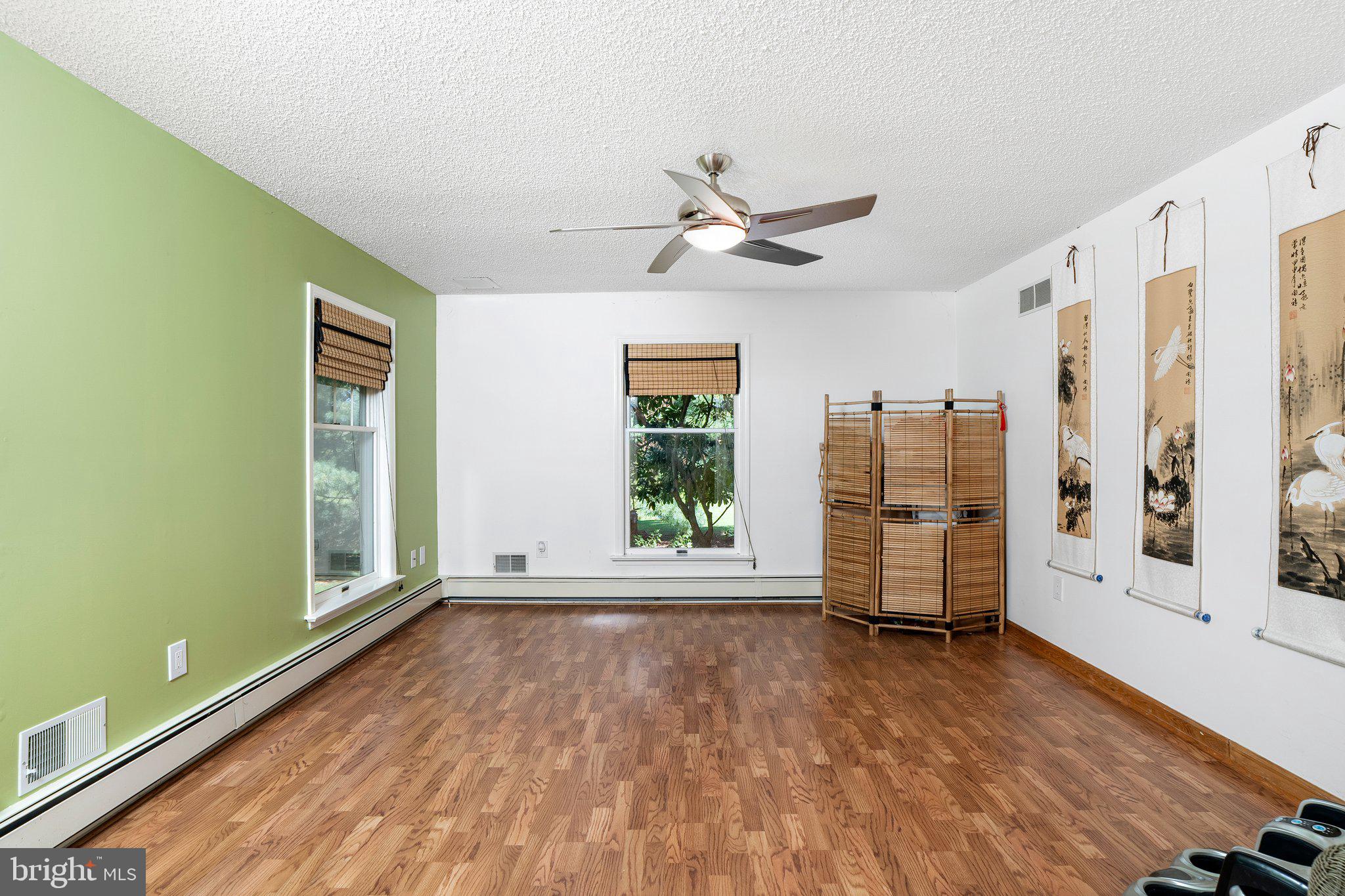 87 Bordentown Chesterfield Road Chesterfield, NJ 08515 - Photo 5 of 49 a view of empty room with wooden floor and fan