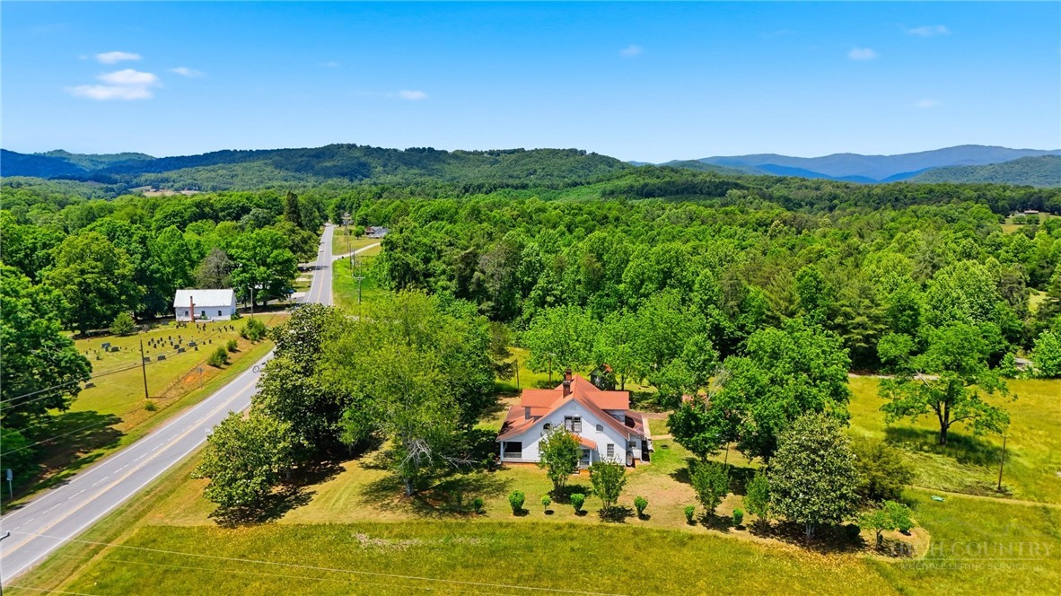 3450 Sparta Road North Wilkesboro, NC 28659 - Photo 29 of 34 a view of a lush green hillside and houses
