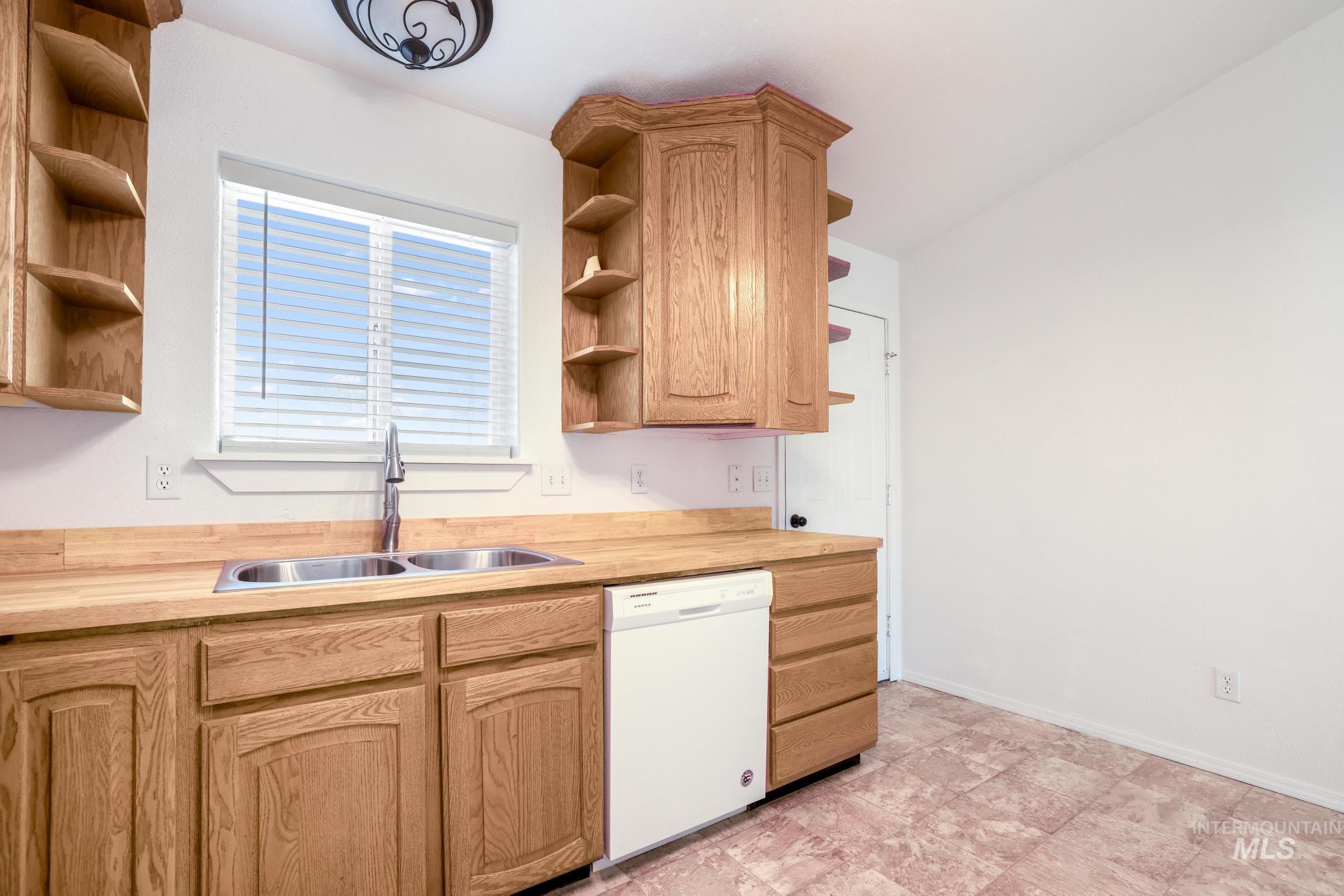 1218 Inca Drive Twin Falls, ID 83301 - Photo 11 of 27 Kitchen with open shelves, dishwasher, wood counters, and light wood finish cabinetry