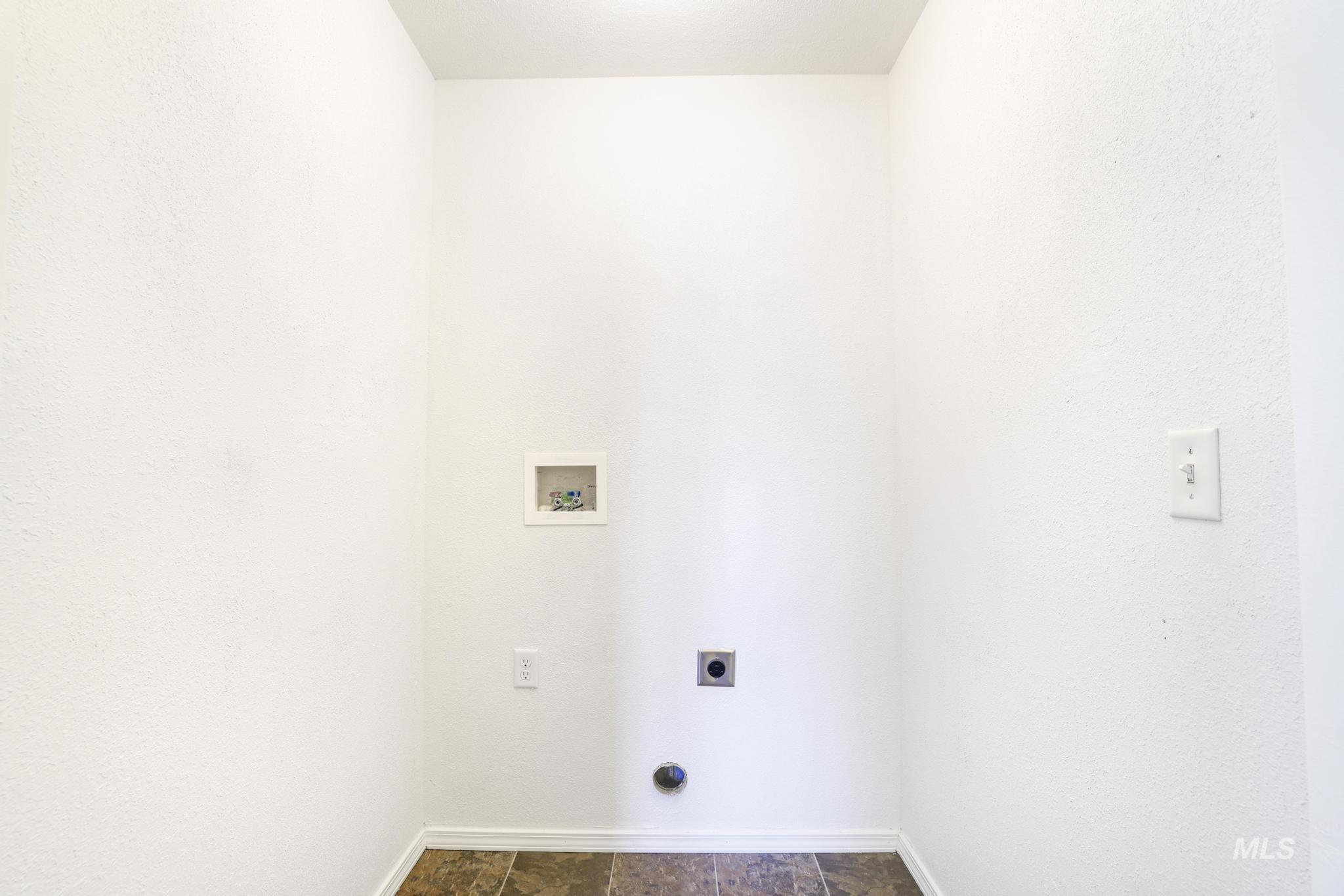 1218 Inca Drive Twin Falls, ID 83301 - Photo 12 of 27 Laundry area with stone finish floors, hookup for an electric dryer, washer hookup, and a textured wall
