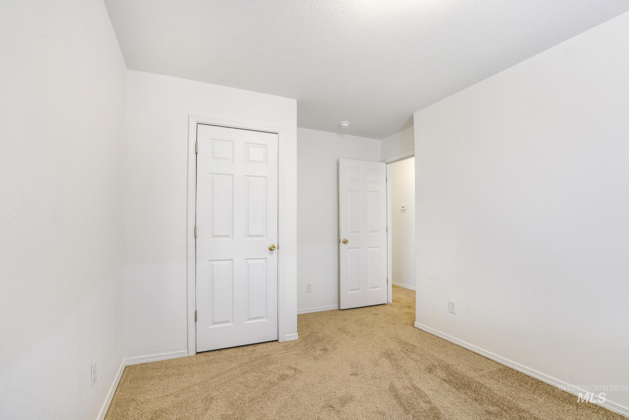1218 Inca Drive Twin Falls, ID 83301 - Photo 20 of 27 Unfurnished bedroom featuring light carpet and baseboards