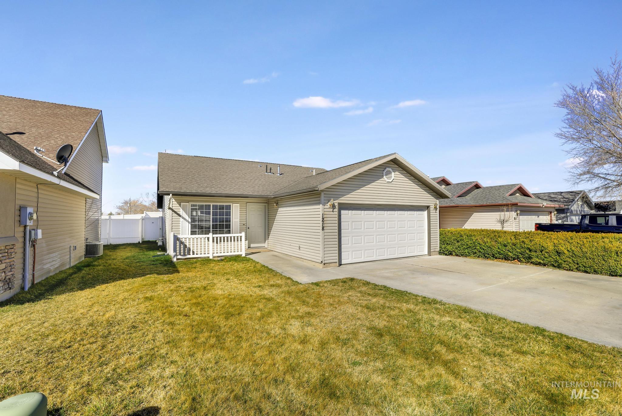 1218 Inca Drive Twin Falls, ID 83301 - Photo 2 of 27 View of front of home with driveway, an attached garage, and roof with shingles