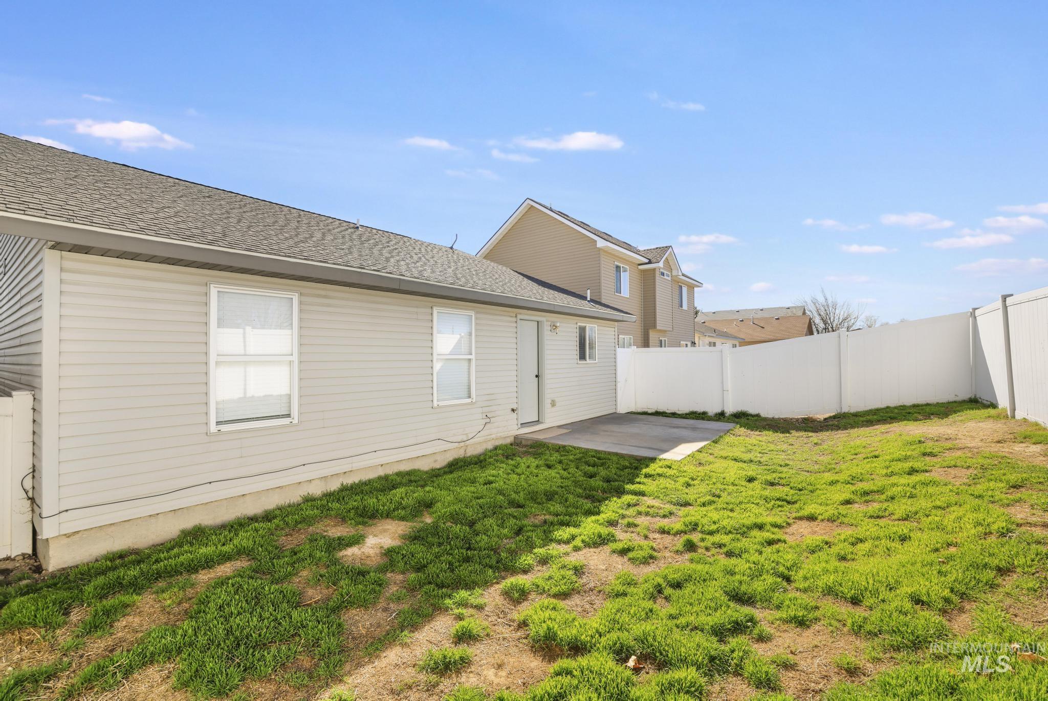 1218 Inca Drive Twin Falls, ID 83301 - Photo 24 of 27 Back of property with a patio, a fenced backyard, and a shingled roof