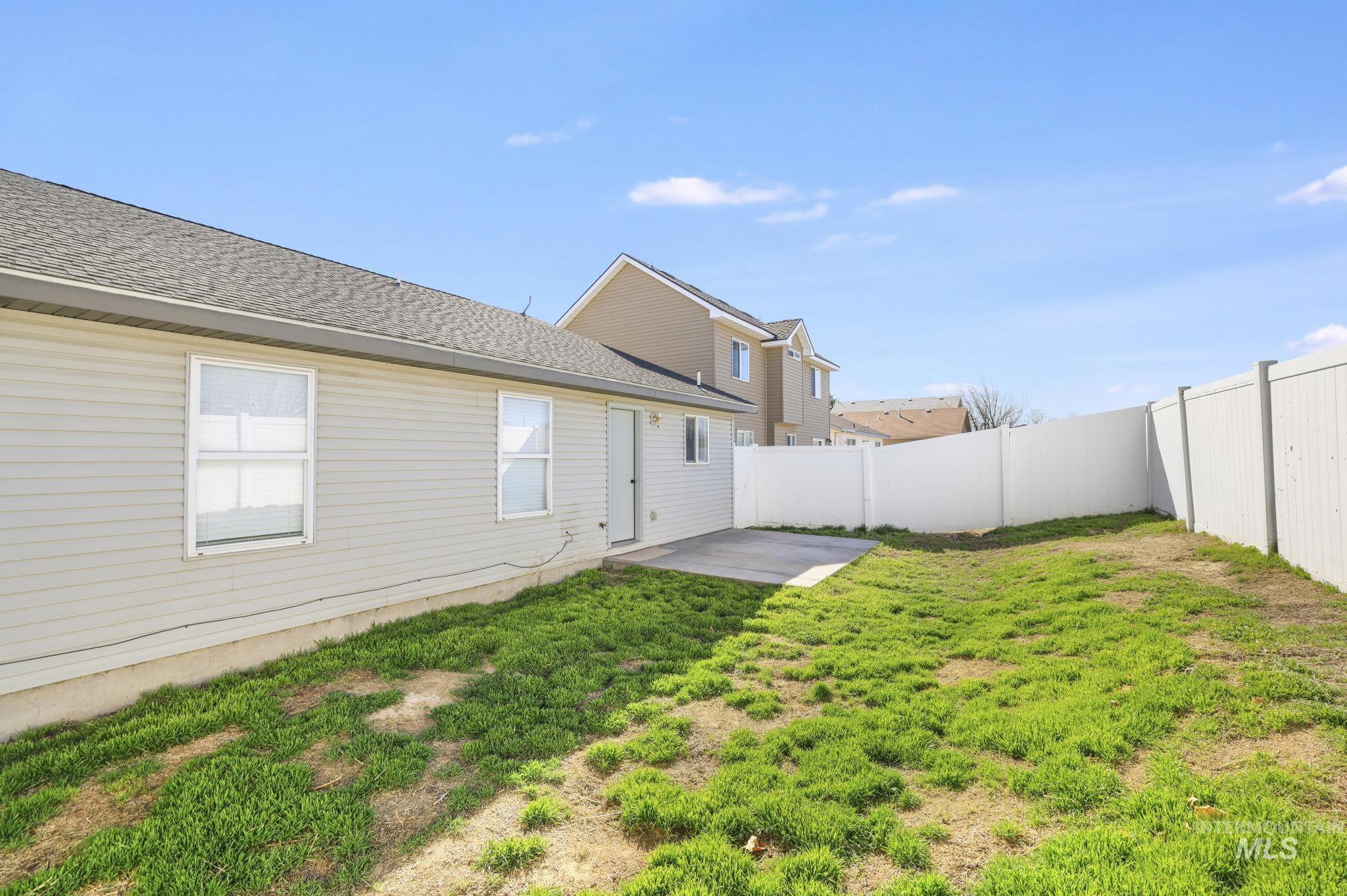 1218 Inca Drive Twin Falls, ID 83301 - Photo 25 of 27 Rear view of house featuring a patio area, a shingled roof, and a fenced backyard