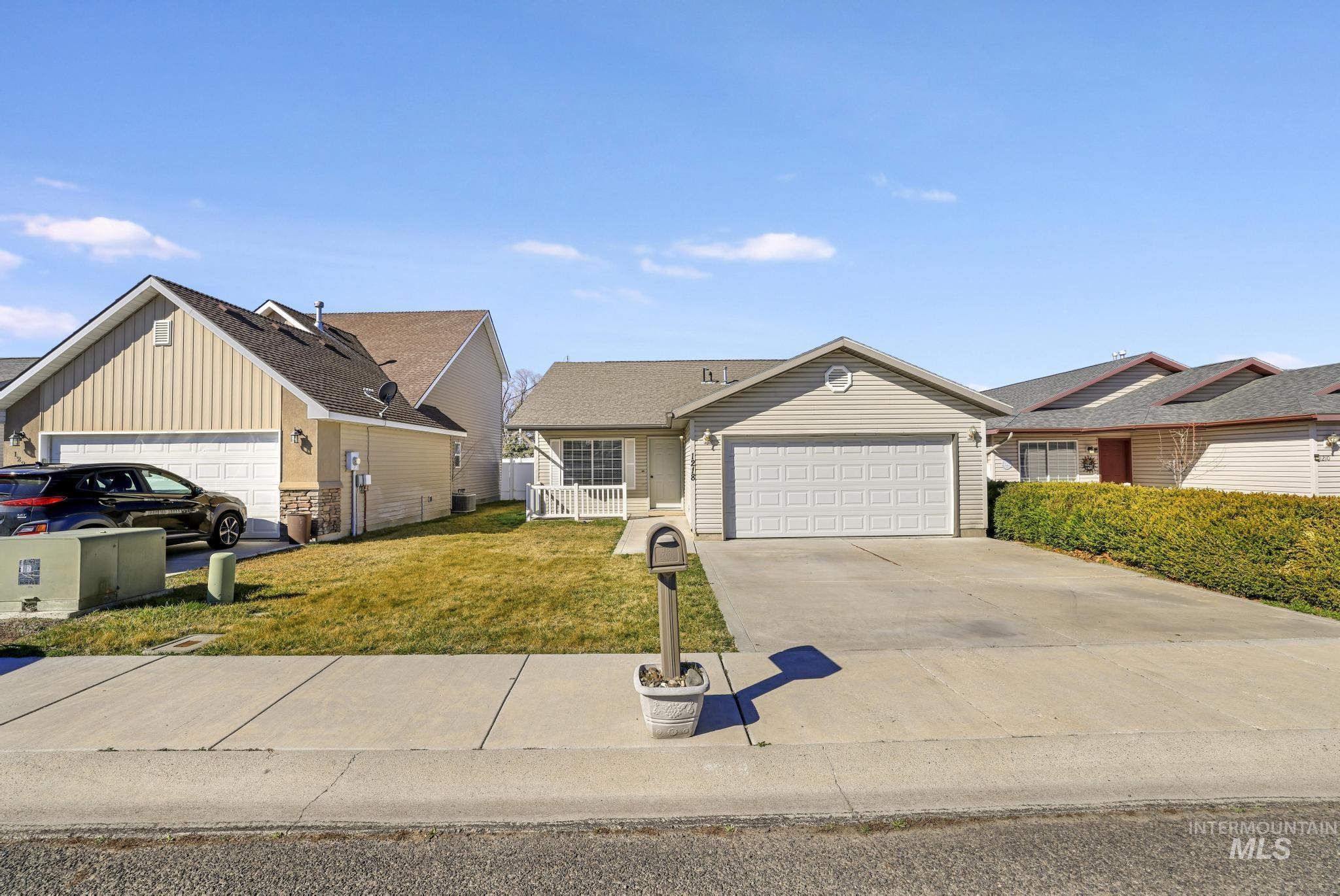 1218 Inca Drive Twin Falls, ID 83301 - Photo 27 of 27 Ranch-style home with a front yard, a garage, driveway, and a residential view