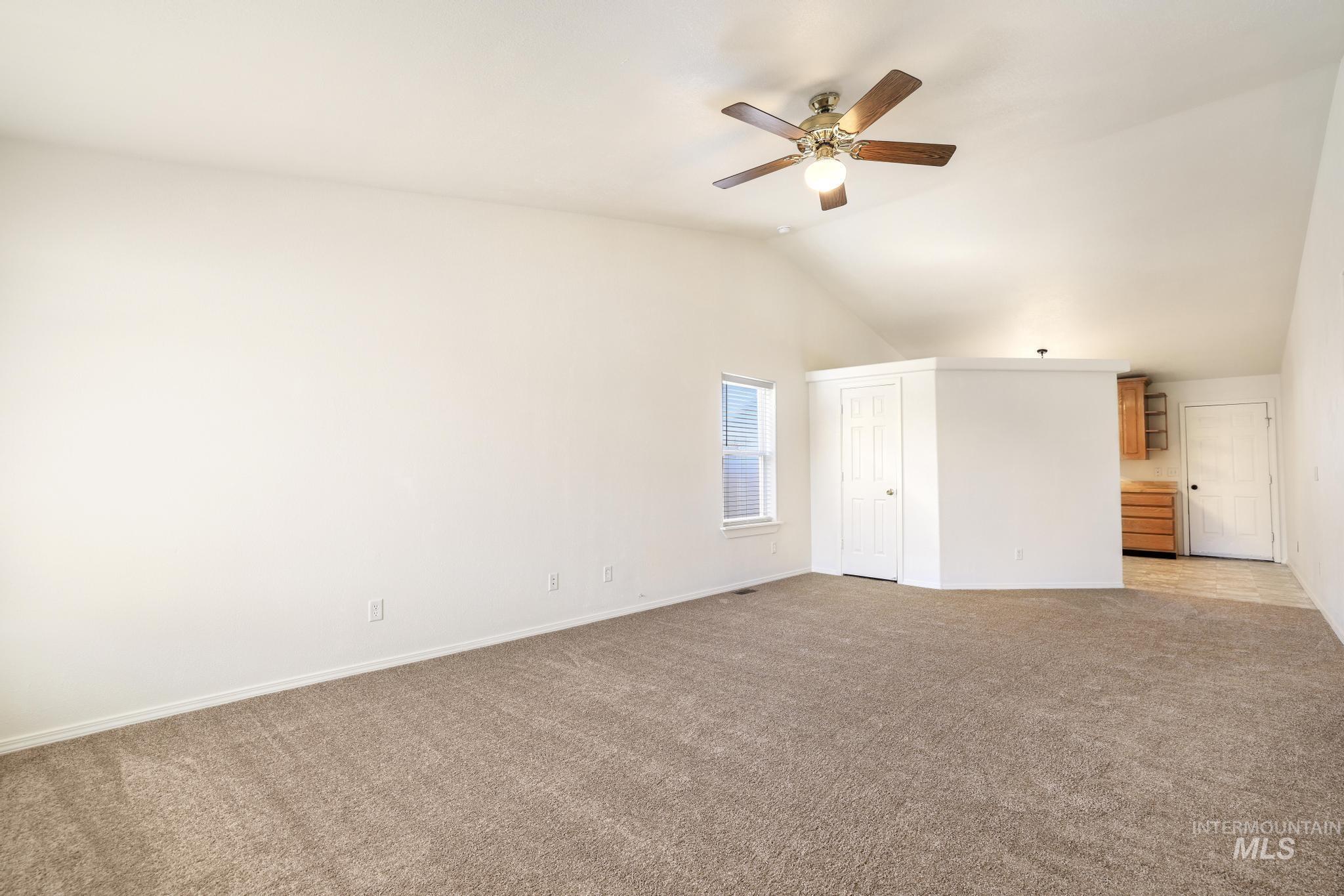 1218 Inca Drive Twin Falls, ID 83301 - Photo 4 of 27 Unfurnished bedroom featuring light colored carpet, a ceiling fan, and a high ceiling