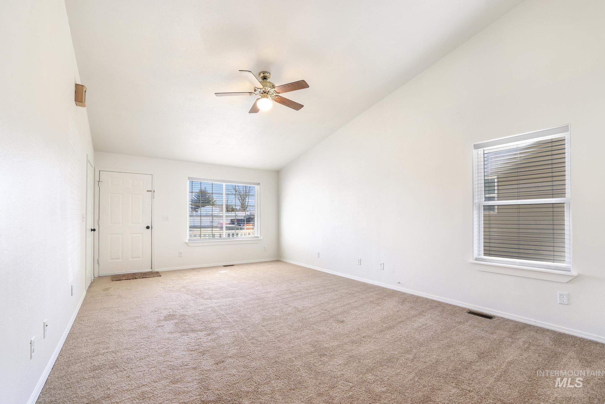 1218 Inca Drive Twin Falls, ID 83301 - Photo 6 of 27 Empty room with carpet flooring, a ceiling fan, and lofted ceiling