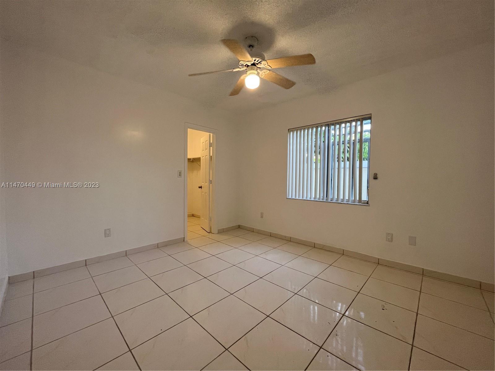 2988 Southwest 11th Street, Unit 2988 Miami, FL 33135 - Photo 12 of 22 a view of an empty room with chandelier fan