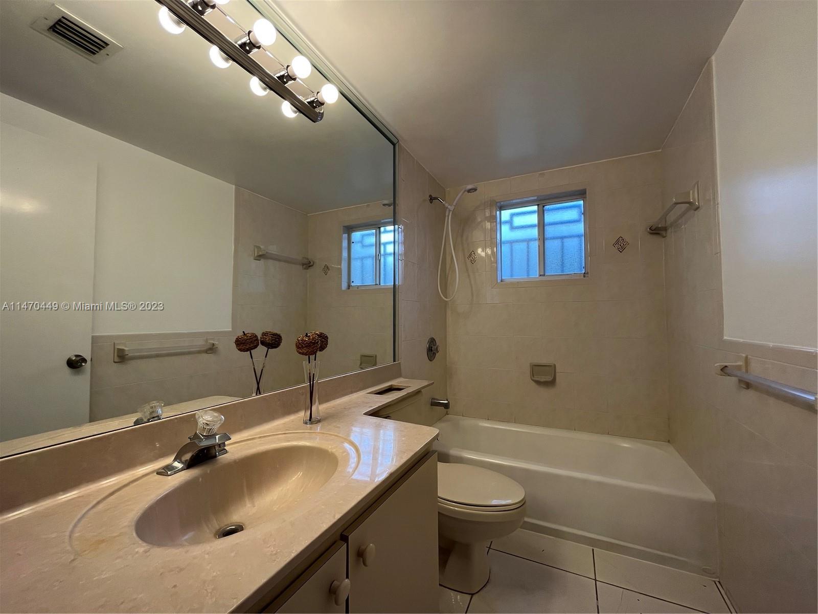 2988 Southwest 11th Street, Unit 2988 Miami, FL 33135 - Photo 14 of 22 a bathroom with a granite countertop sink a toilet and shower