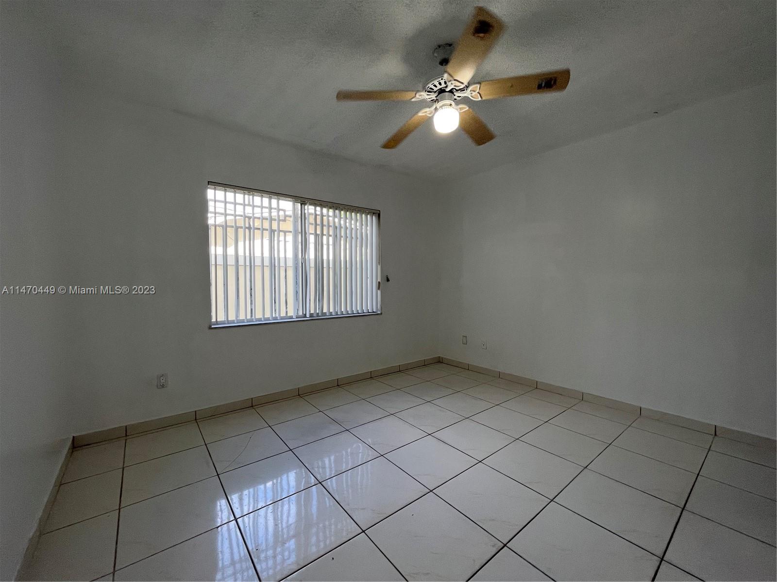 2988 Southwest 11th Street, Unit 2988 Miami, FL 33135 - Photo 17 of 22 an empty room with windows and fan