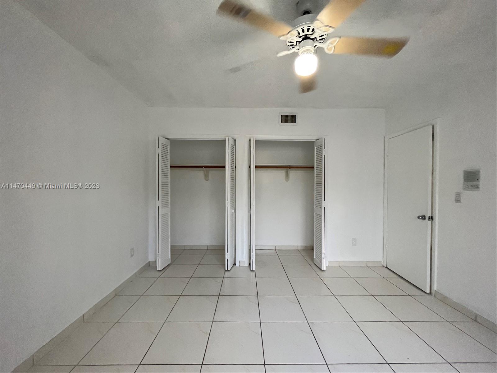 2988 Southwest 11th Street, Unit 2988 Miami, FL 33135 - Photo 18 of 22 a view of an empty room and chandelier fan