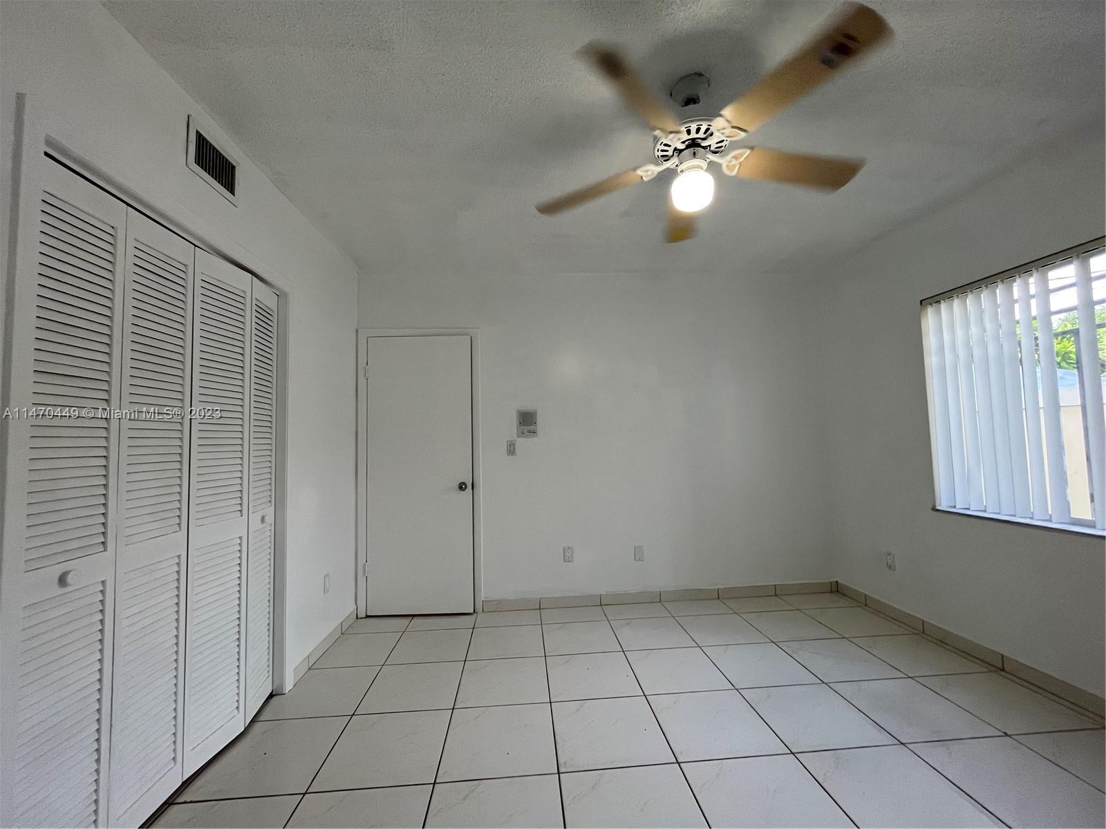 2988 Southwest 11th Street, Unit 2988 Miami, FL 33135 - Photo 19 of 22 a view of an empty room with a window