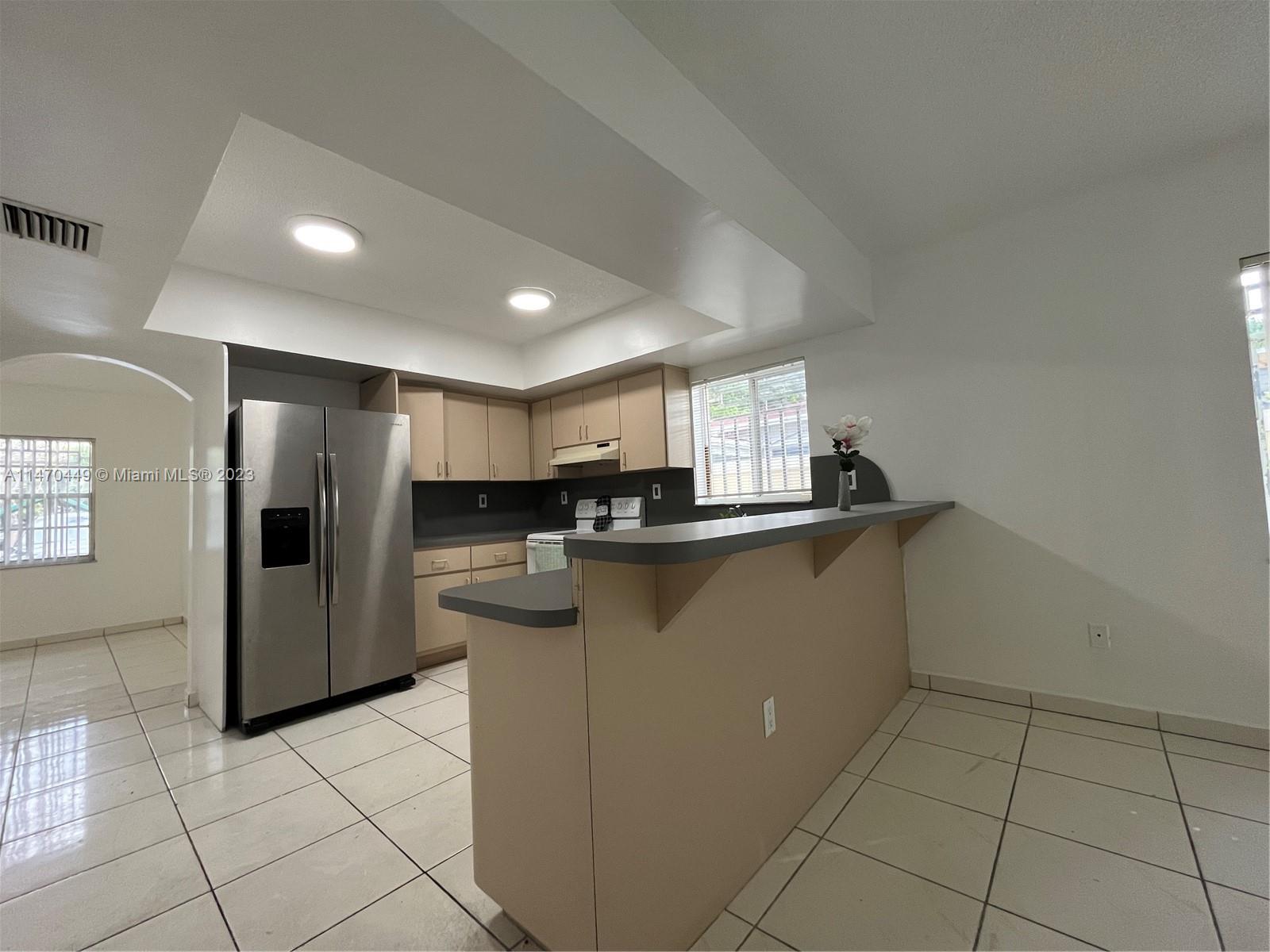 2988 Southwest 11th Street, Unit 2988 Miami, FL 33135 - Photo 4 of 22 a kitchen with stainless steel appliances a refrigerator sink and microwave