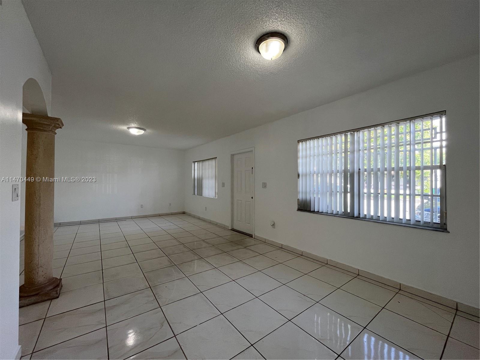 2988 Southwest 11th Street, Unit 2988 Miami, FL 33135 - Photo 6 of 22 an empty room with windows