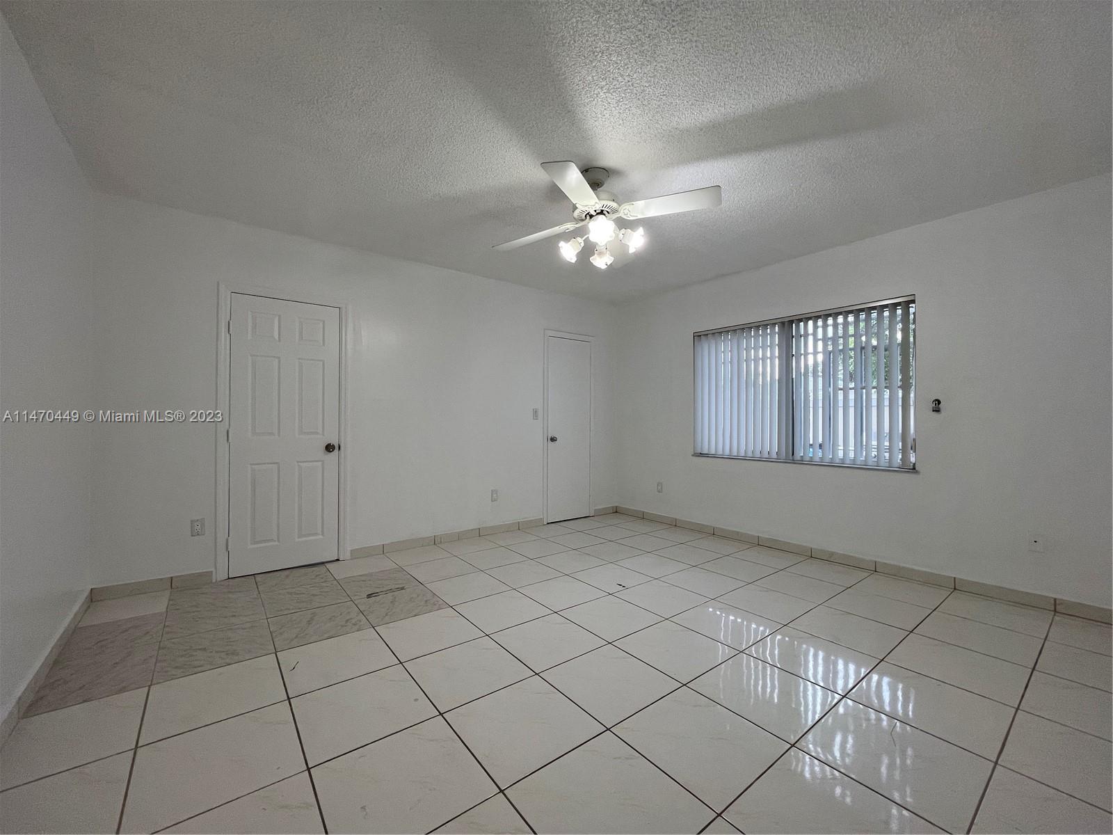 2988 Southwest 11th Street, Unit 2988 Miami, FL 33135 - Photo 9 of 22 an empty room with windows and fan