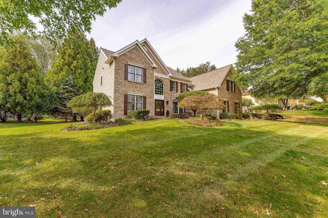 a front view of a house with a big yard and potted plants