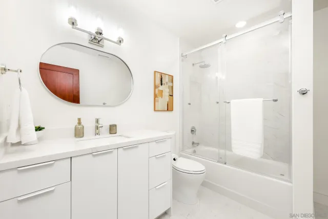 a bathroom with a toilet sink and a mirror