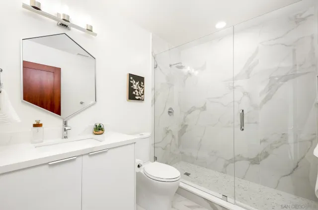 a bathroom with a sink toilet and shower