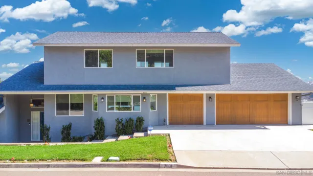 a view of a brick house with a yard