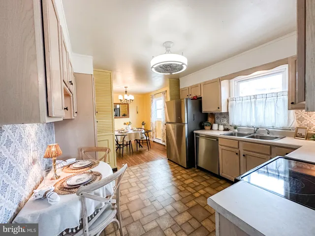 a kitchen with a sink refrigerator and cabinets