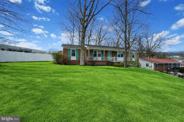 a front view of house with yard and green space