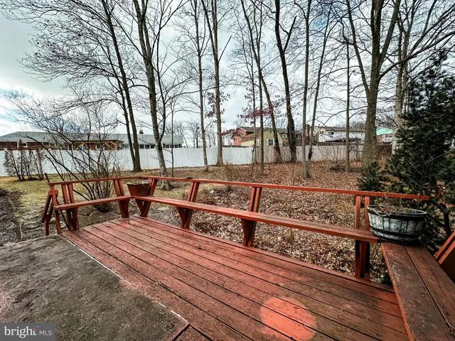 a backyard of a house with trees and outdoor seating