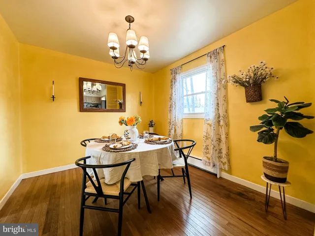 a view of a dining room with furniture and chandelier
