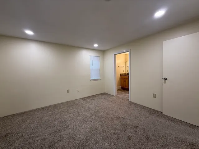 an empty room with windows and closet
