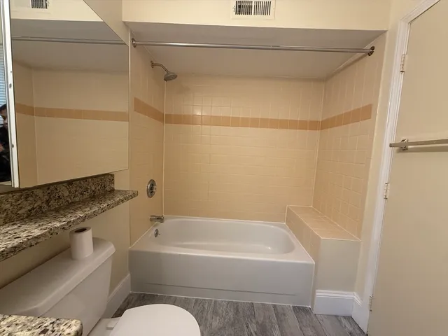 a bathroom with a bathtub and a shower