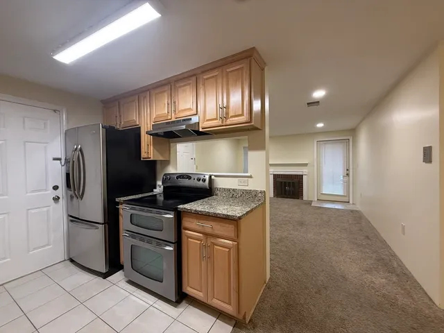 a kitchen with cabinets and stainless steel appliances