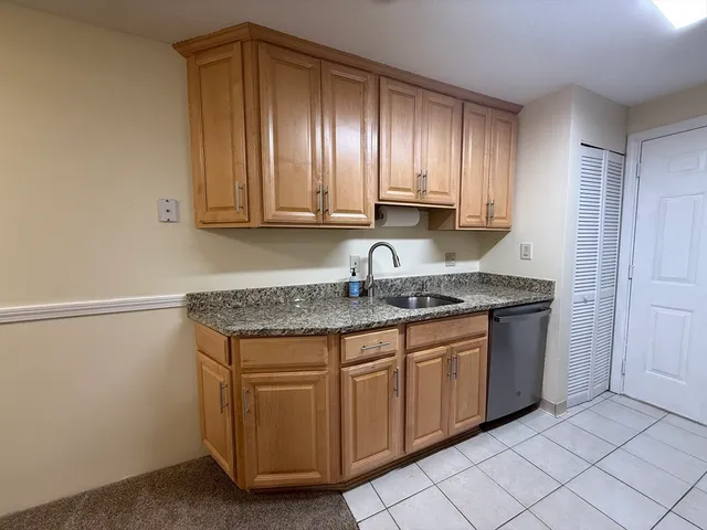 a kitchen with stainless steel appliances granite countertop a sink and a stove