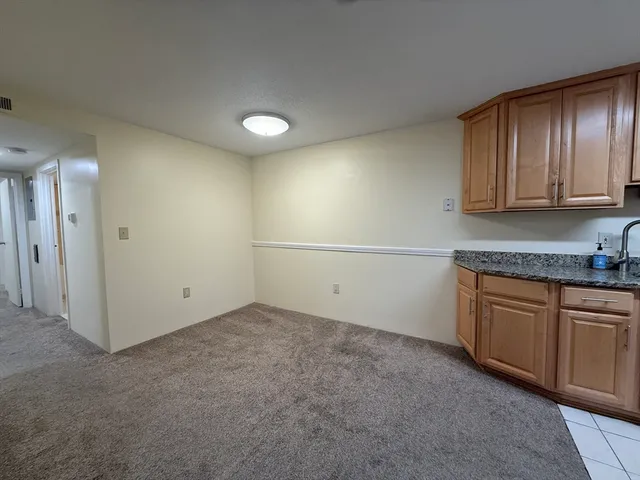 a view of a kitchen with granite countertop cabinets