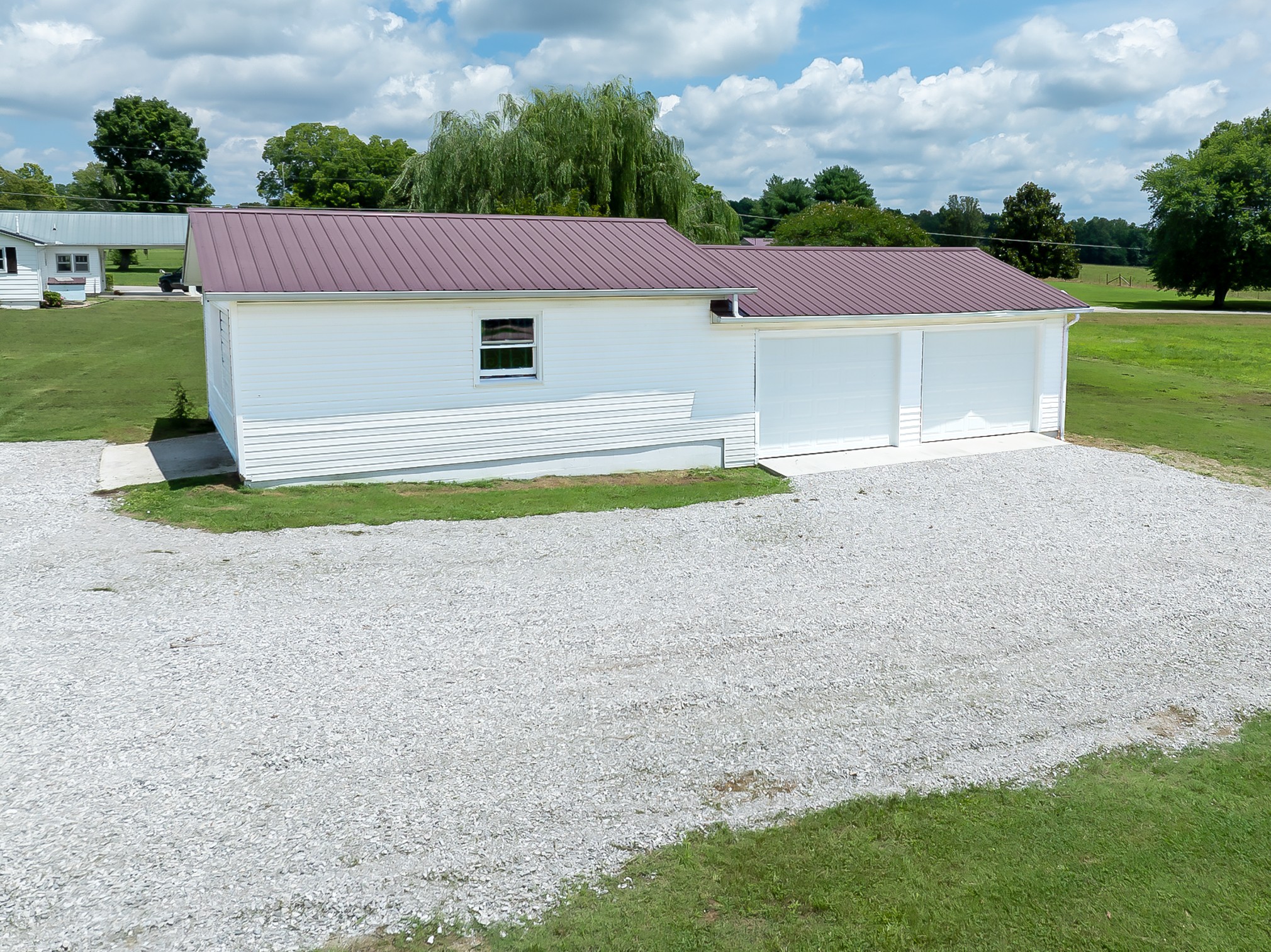 6606 Old Tullahoma Road Winchester, TN 37398 - Photo 38 of 42 a front view of a house with a yard and garage