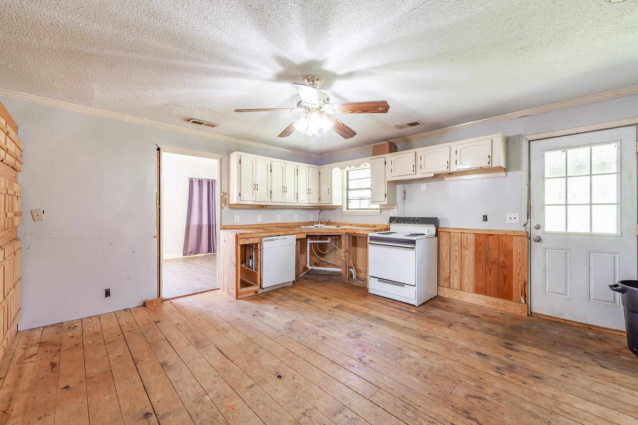 3249 Beech Bluff Road Beech Bluff, TN 38313 - Photo 23 of 32 a large kitchen with stainless steel appliances granite countertop a stove and a refrigerator