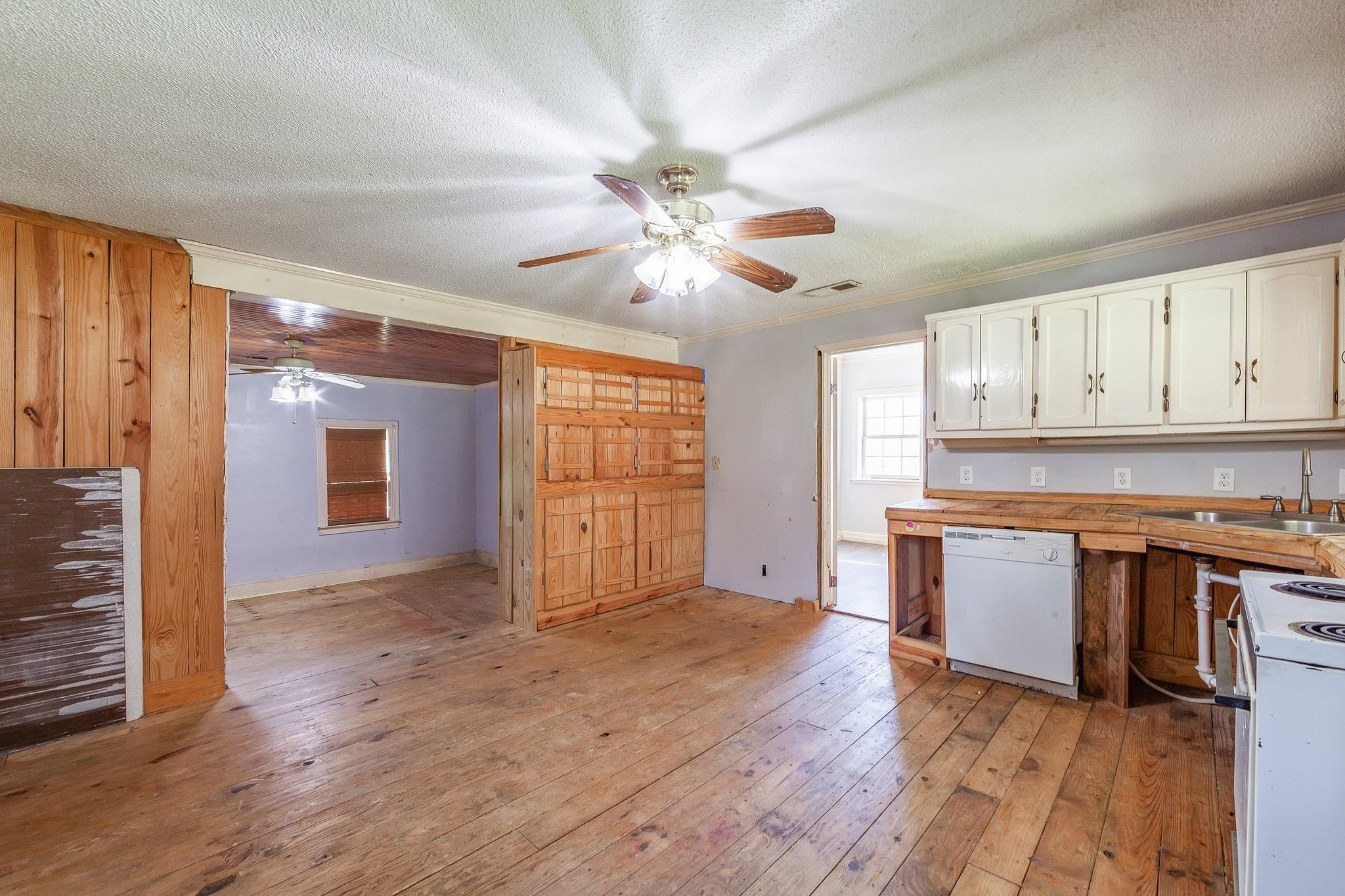 3249 Beech Bluff Road Beech Bluff, TN 38313 - Photo 24 of 32 an empty room with wooden floor a kitchen view and a window
