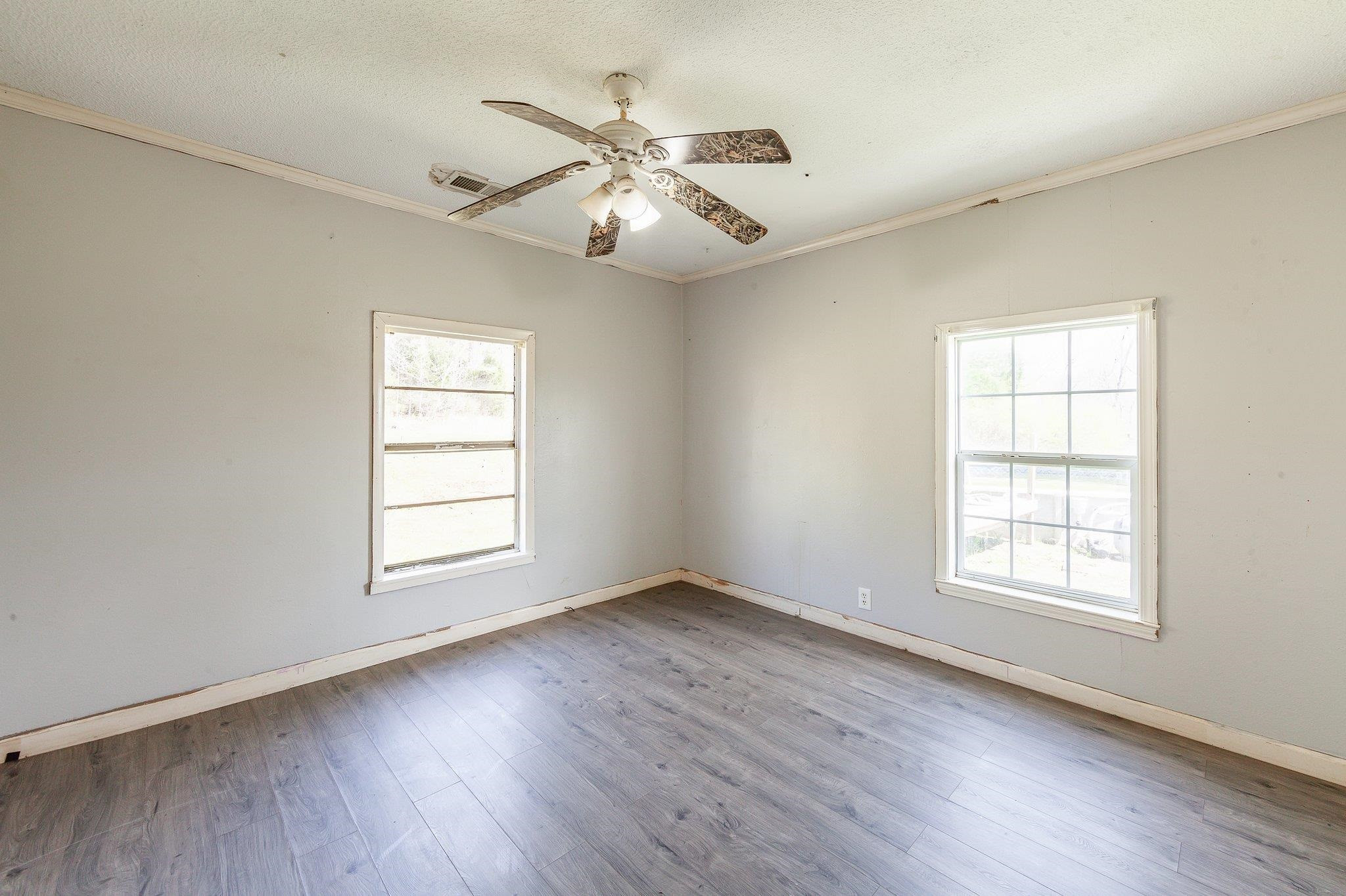 3249 Beech Bluff Road Beech Bluff, TN 38313 - Photo 28 of 32 an empty room with wooden floor fan and windows