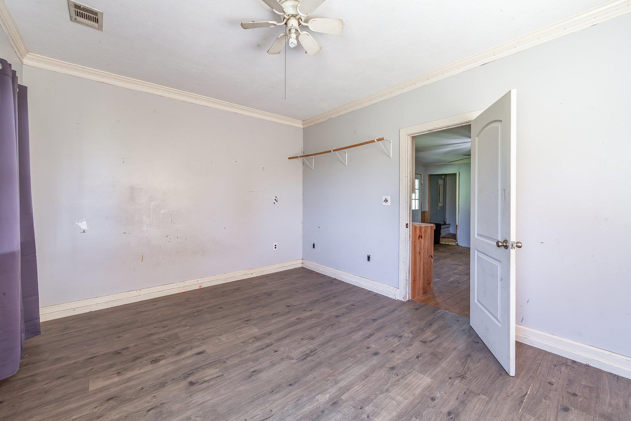 3249 Beech Bluff Road Beech Bluff, TN 38313 - Photo 32 of 32 an empty room with wooden floor and entryway