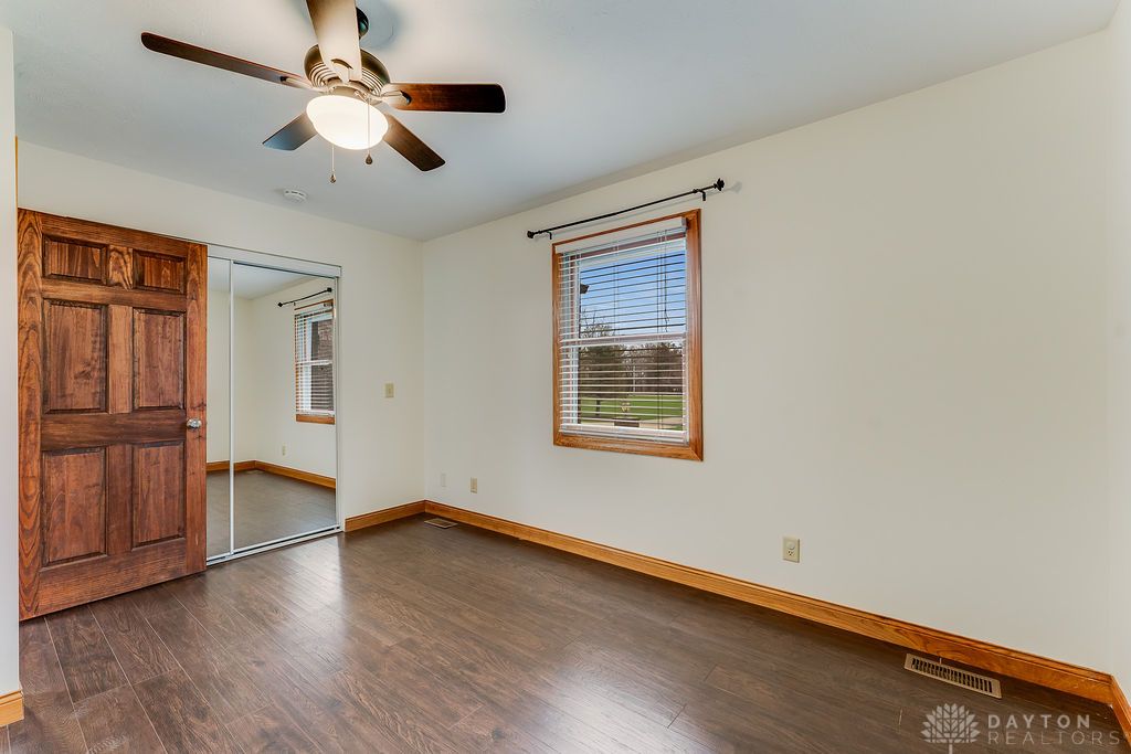 7400 Cook-Jones Road Waynesville, OH 45068 - Photo 25 of 72 This spacious room features rich wood flooring, a window offering serene views, and ample natural light.