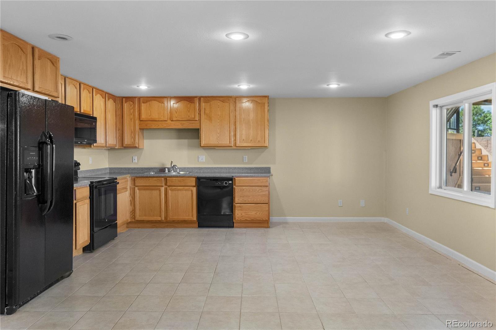 74 Rocky Cliff Road Elizabeth, CO 80107 - Photo 34 of 50 a kitchen with stainless steel appliances granite countertop a stove a sink dishwasher a refrigerator and a refrigerator