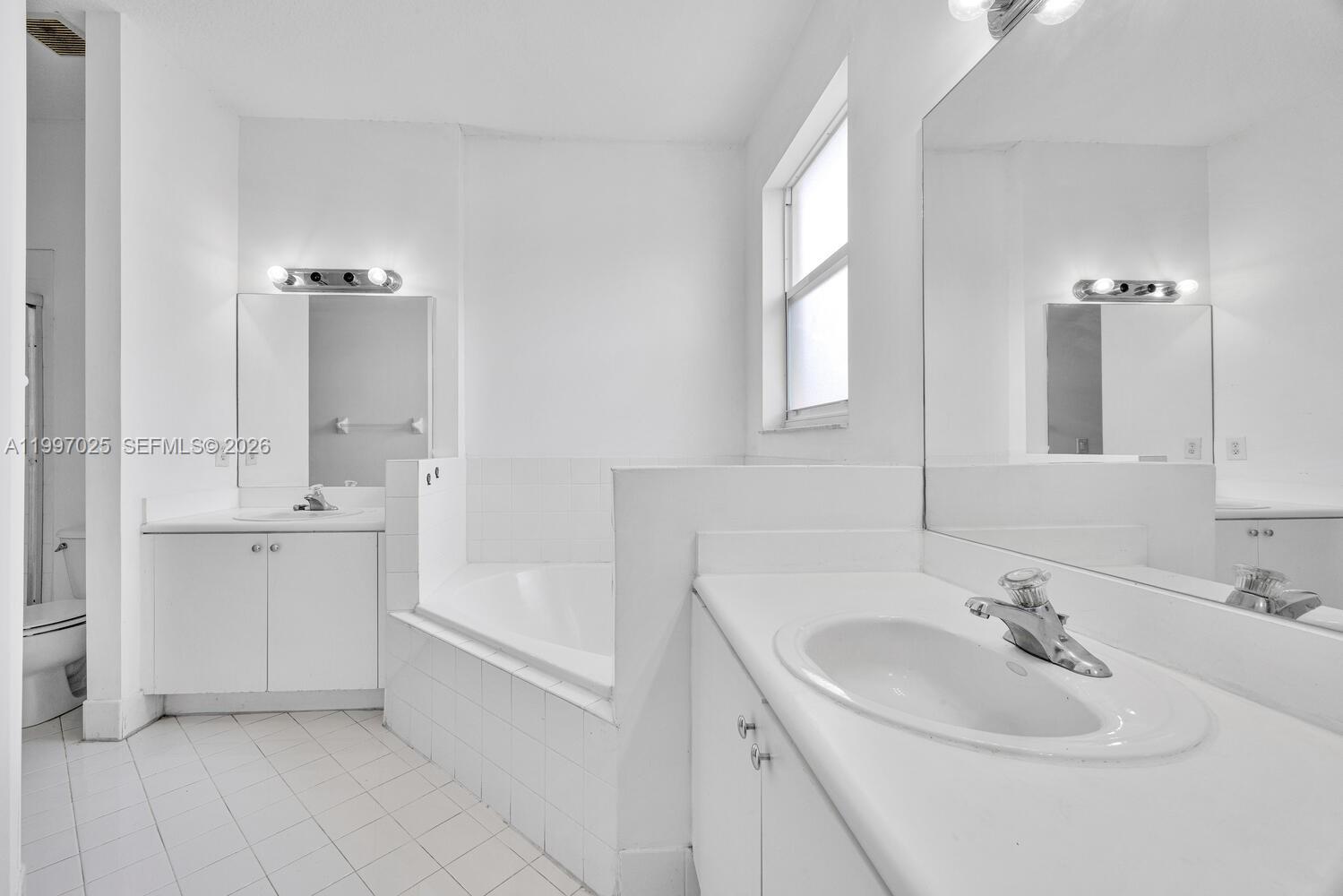 12864 Southwest 133rd Terrace Miami, FL 33186 - Photo 12 of 26 a bathroom with a sink and a bathtub
