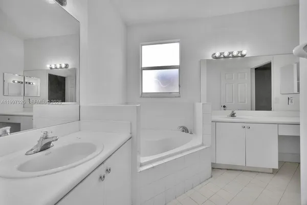 a bathroom with a bathtub sink and mirror