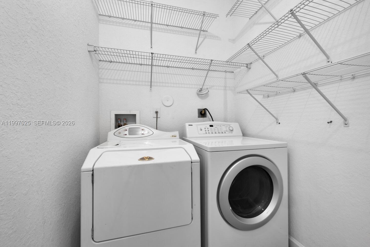 12864 Southwest 133rd Terrace Miami, FL 33186 - Photo 18 of 26 a utility room with dryer and washer