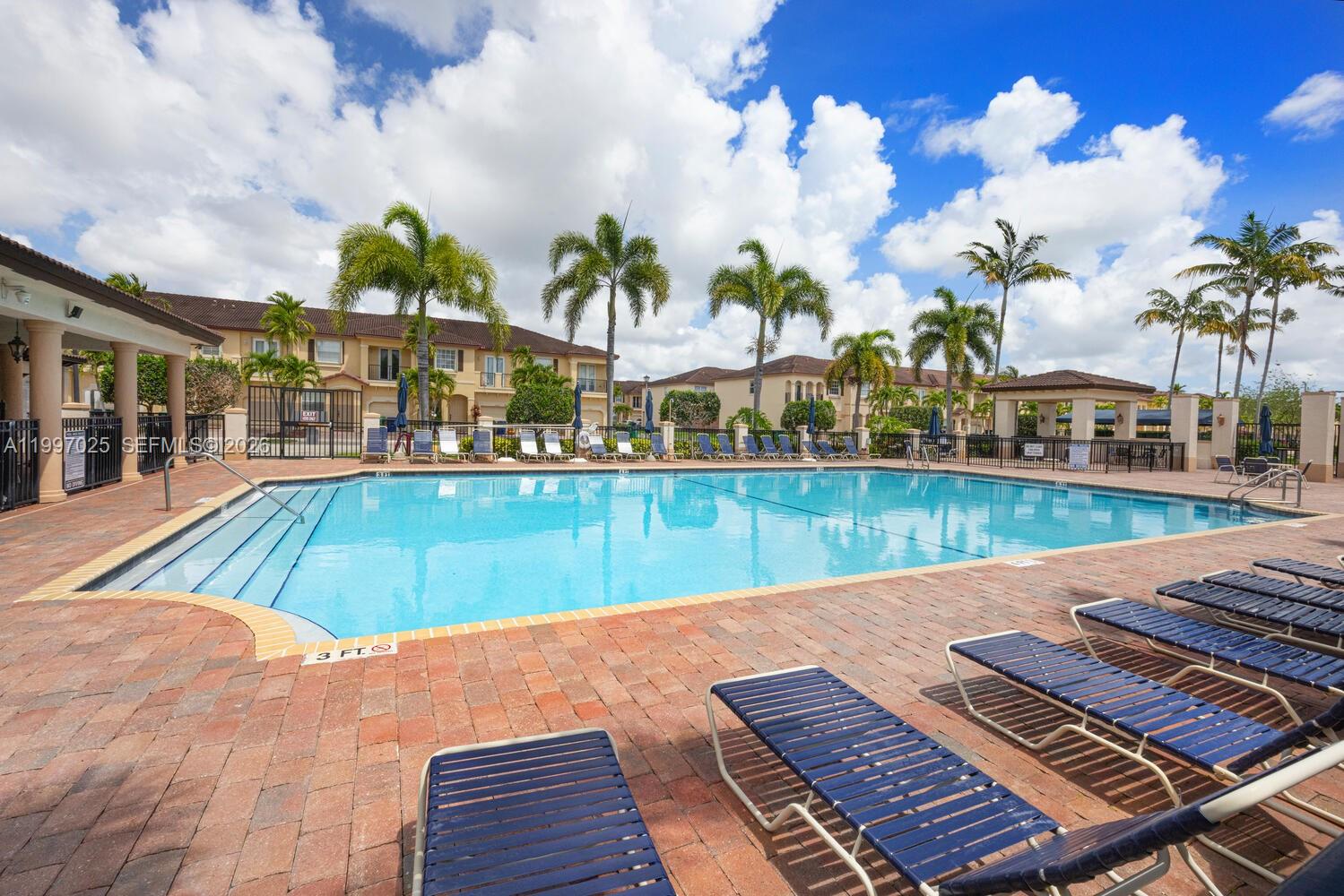 12864 Southwest 133rd Terrace Miami, FL 33186 - Photo 20 of 26 a view of a swimming pool with outdoor seating
