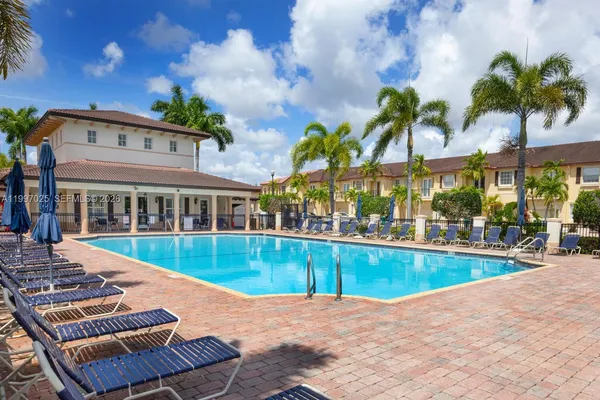 a view of a swimming pool with a lawn chairs
