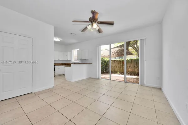 a view of a kitchen with furniture ceiling fan and window